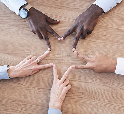 Buy stock photo Hands, star and teamwork overhead with a business team in the office sitting at a boardroom table. Hand sign, shape or collaboration with a man and woman employee group meeting for strategy at work