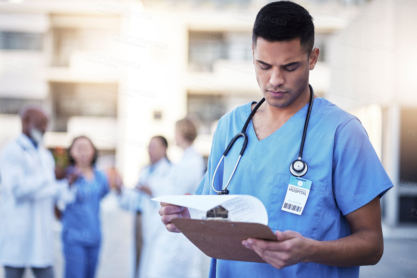 Buy stock photo Healthcare, man and outdoor with clipboard, uniform and reading charts for results, focus and teamwork. Medical professionals, male employee and coworkers with information, diagnosis and documents