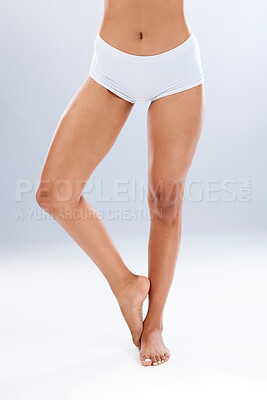 Buy stock photo Legs, skin and epilation with beauty and woman in underwear, skincare and glow on studio background. Feet, pedicure and wellness with laser hair removal, waxing and dermatology with cosmetic care