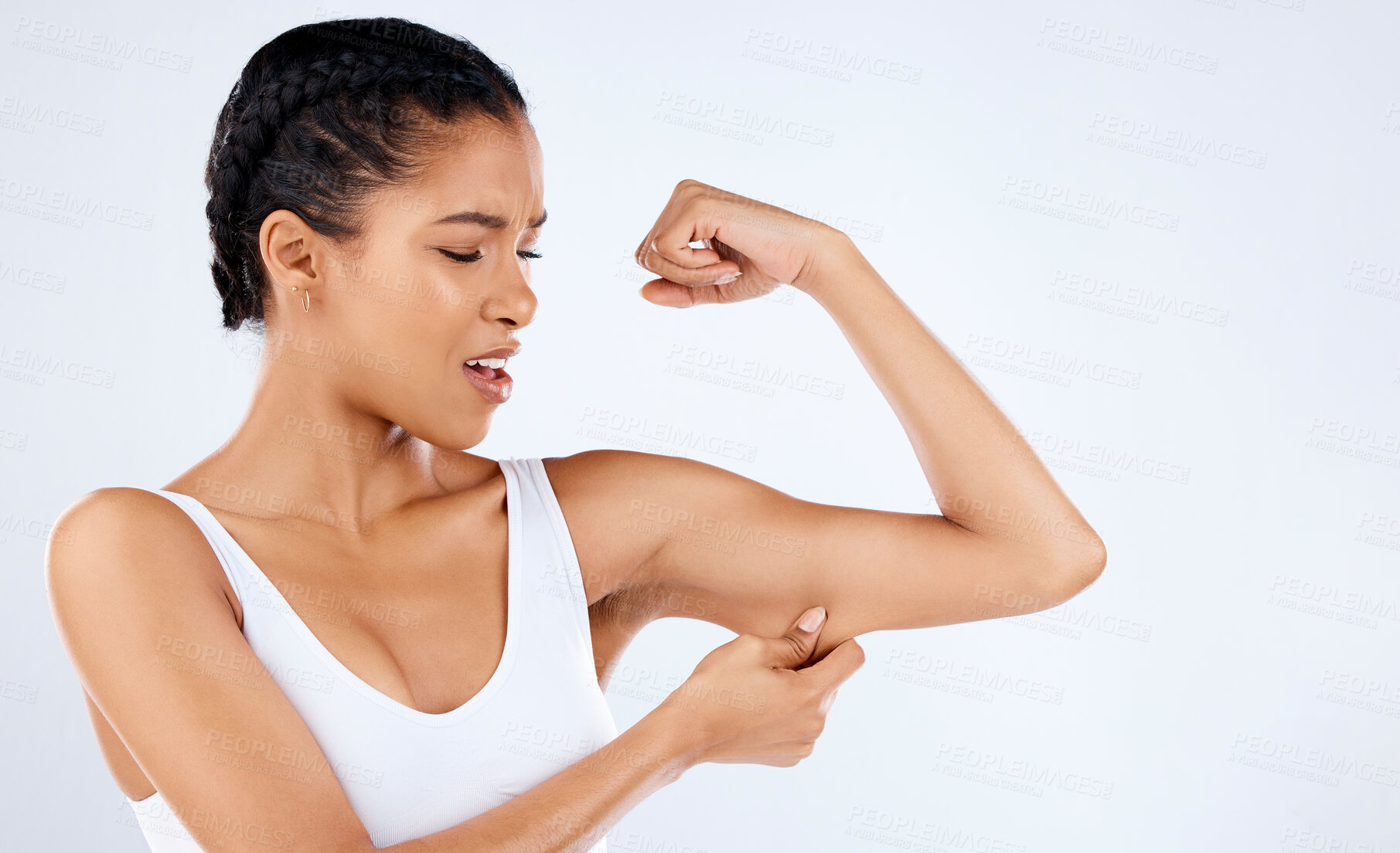 Buy stock photo Arm, fat and body with a black woman in studio pinching her skin on a gray background for diet or weightloss. Wellness, health and beauty with an attractive young female unhappy with her cellulite