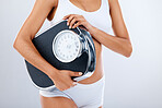 Woman, body and scale with fitness and health, diet or detox to lose weight with exercise, healthy lifestyle and wellness. Nutrition, workout and weightloss, healthcare isolated on studio background