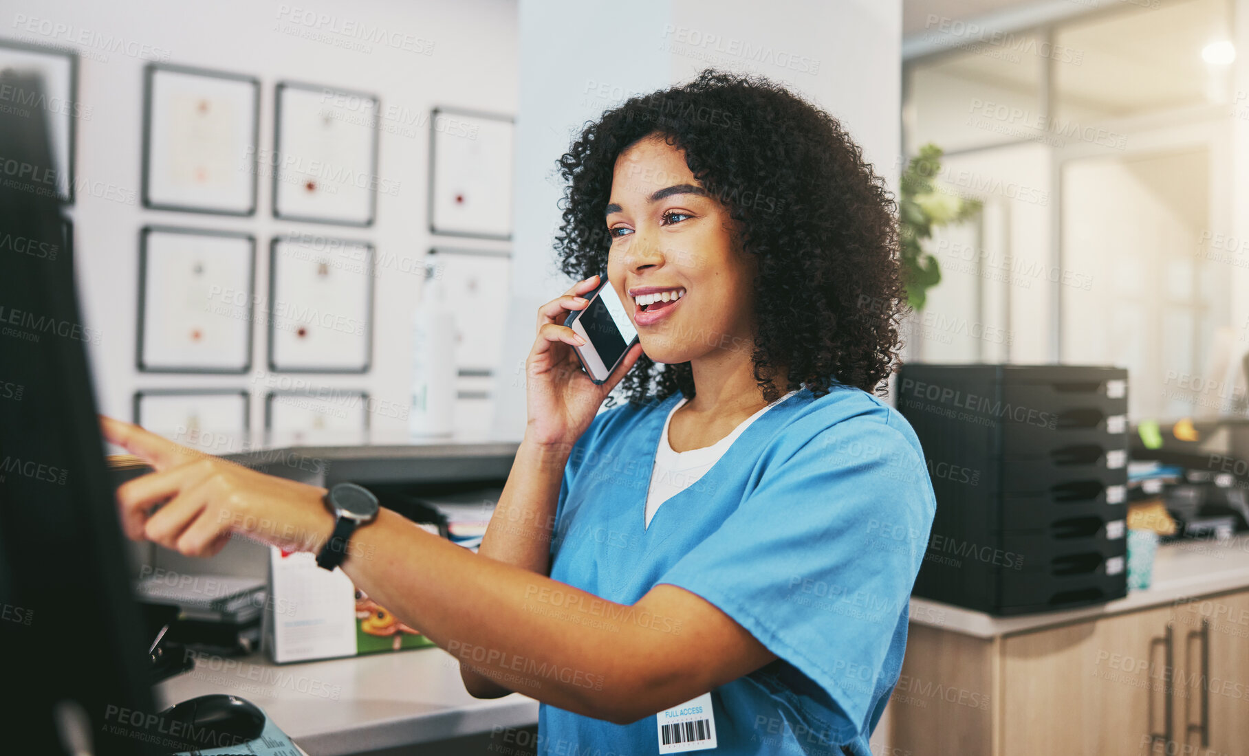 Buy stock photo Phone call, nurse and black woman with computer in hospital for healthcare or telehealth. Medical, question and happy female doctor pointing at desktop while talking or chatting on mobile smartphone.