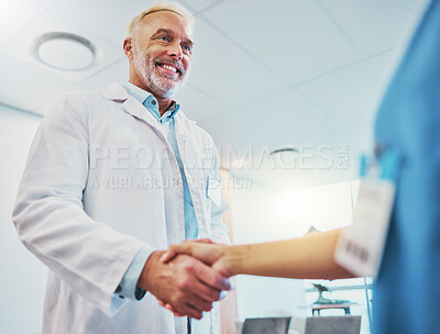 Buy stock photo Healthcare, handshake and doctor in partnership with a nurse for a consultation in the hospital. Happy, smile and senior medical worker shaking hands with colleague for agreement in a medicare clinic
