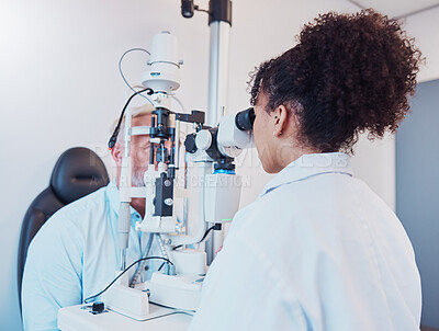 Buy stock photo Optometry, eye exam and ophthalmologist testing patient vision or eyes using a slit lamp machine by a doctor. Healthcare, eyecare and medical insurance professional doing a visual examination on man