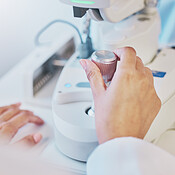 Ophthalmology, test and hand of a doctor on a machine for a ...