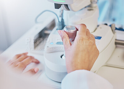 Buy stock photo Ophthalmology, test and hand of a doctor on a machine for a consultation, vision check and monitor lens. Medicine, healthcare and optician moving a handle on equipment for analysis of eyes and retina