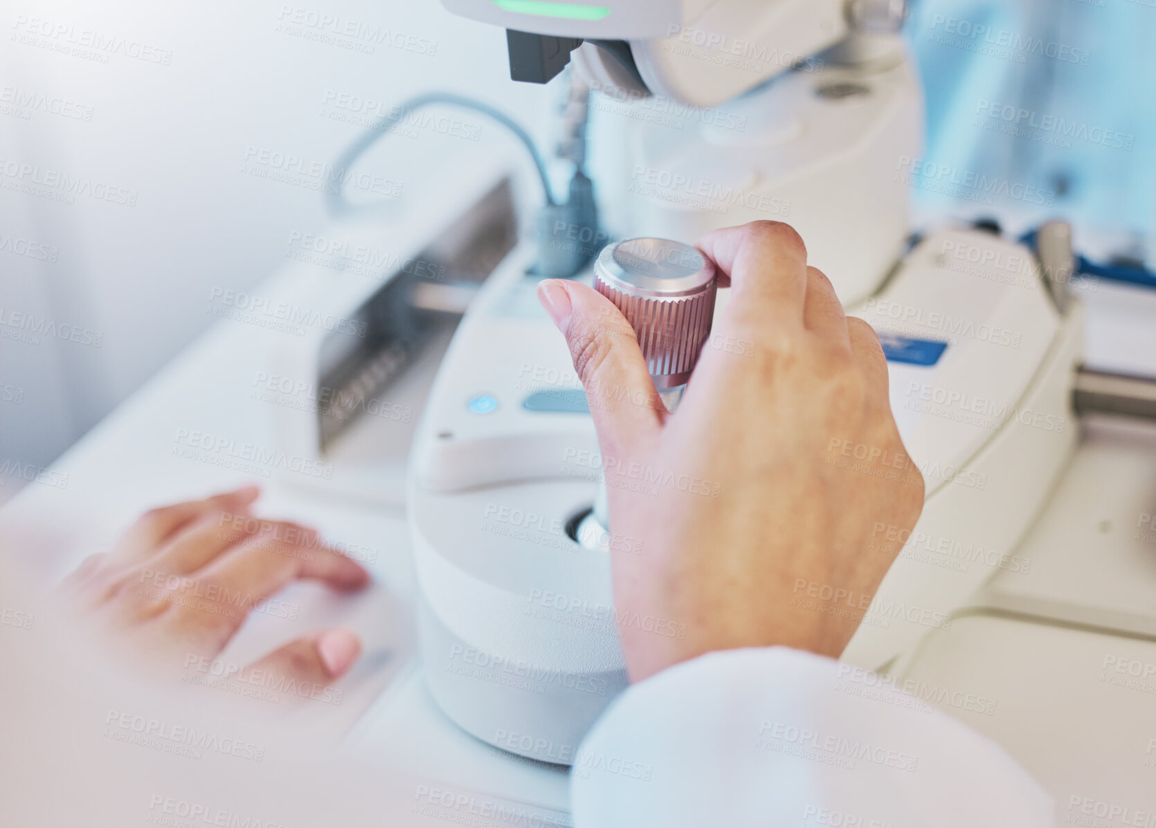 Buy stock photo Ophthalmology, test and hand of a doctor on a machine for a consultation, vision check and monitor lens. Medicine, healthcare and optician moving a handle on equipment for analysis of eyes and retina