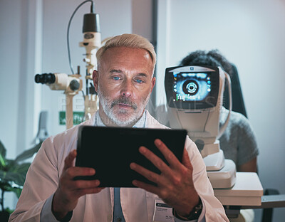 Buy stock photo Digital tablet, optometry and man in a clinic doing optic research during eye care consultation. Ophthalmology, healthcare and senior male optometrist working on mobile device while doing vision test
