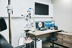 Ophthalmology, computer and empty room with equipment for vision, healthcare and consultation. Technology, professional and consulting office with a chair for care of eyes and a monitor for results