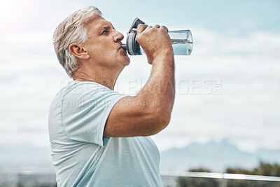 Buy stock photo Senior man, fitness and drinking water for hydration or thirst after workout, exercise or training in nature. Elderly male having refreshing natural liquid drink from intense cardio in the outdoors