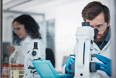 Buy stock photo Man, doctor and forensic science with microscope for examination, experiment or test at the laboratory. Male scientist looking at micro organisms for exam, breakthrough or testing to find cure at lab