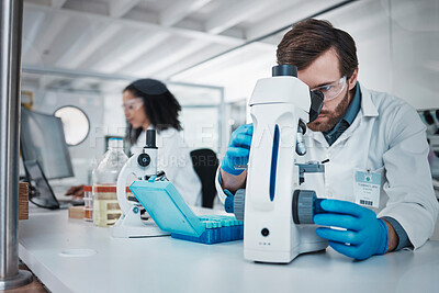 Buy stock photo Man, doctor and forensic scientist with microscope for examination, experiment or test at laboratory. Male in science looking at micro organisms for exam, breakthrough or testing to find cure at lab