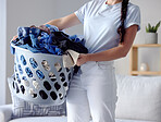 Laundry, clothes and woman with basket for cleaning, housework and washing fabric in living room. Housekeeping service, spring clean and girl holding wash container for fabric, material and clothing