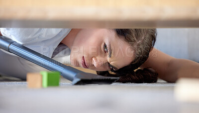 Buy stock photo Face of woman with vacuum under couch or bed, house work, dirt and frustrated mom cleaning toys on floor. Chores, mess and room, housekeeper annoyed, vacuuming and working in messy apartment or home.