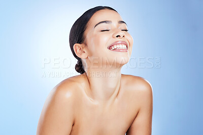 Buy stock photo Skincare, beauty and smile of a woman happy about wellness, facial and dermatology. Isolated, blue background and studio with a young model with happiness from self care and spa treatment detox