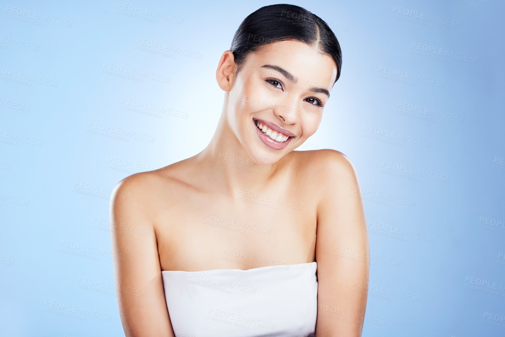 Buy stock photo Skincare, beauty and portrait of young woman with makeup and face cleaning in studio. Happy, cosmetics and facial wellness of female with self care and cosmetic treatment in isolated blue background