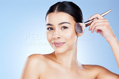 Buy stock photo Makeup, beauty and portrait of woman with brush on blue background for cosmetics, powder and foundation. Skincare, spa aesthetic and face of girl with cosmetology tool for facial products in studio