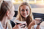 Coffee cup, couple of friends and happy social date or conversation in morning for gen z lifestyle. Young people or youth women talking together with latte in cafe shop or restaurant on student break