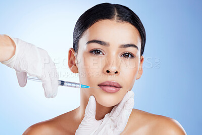 Plastic surgery, woman and surgeon hands for beauty, filler syringe and change in studio. Aesthetic model person and doctor for cosmetic surgery, face transformation or dermatology blue background
