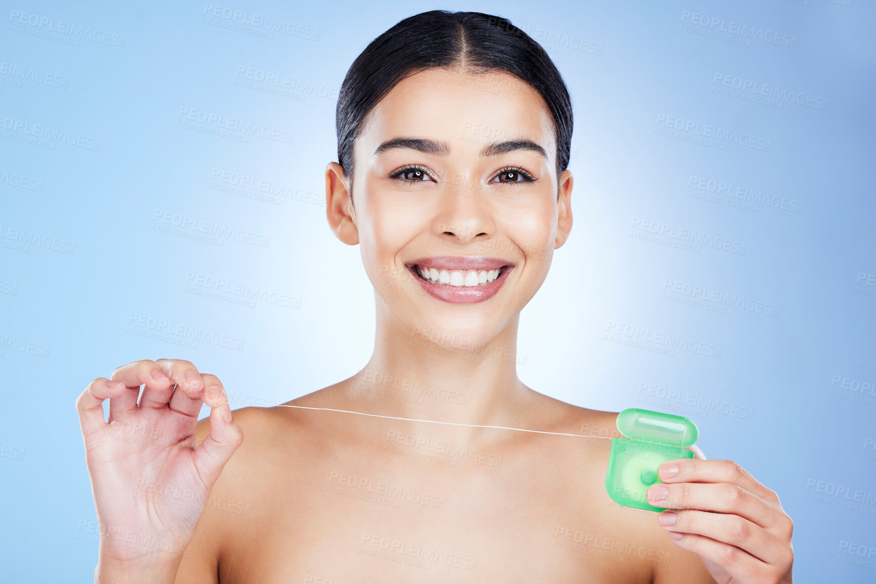 Buy stock photo Face, floss teeth and dental with woman, hygiene and beauty with grooming and container on blue background. Hands, string and oral care product, healthy gums with fresh breath, health and portrait