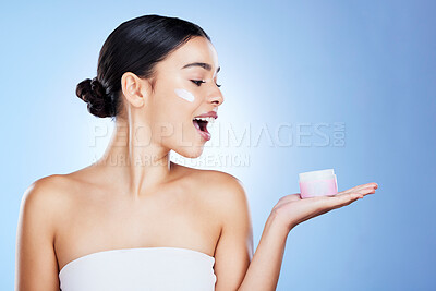 Buy stock photo Woman, face and surprise for skincare moisturizer, cosmetics or beauty against a blue studio background. Portrait of happy female shocked with product, lotion or cream for facial treatment on mockup