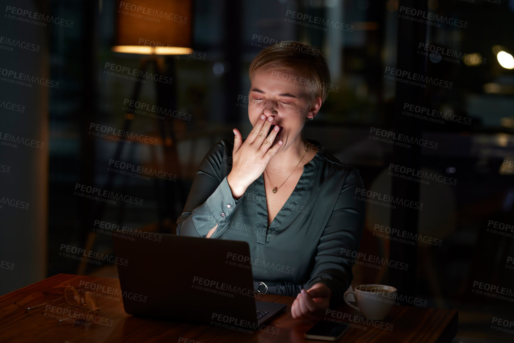 Buy stock photo Tired, late and woman working on a laptop, yawning and feeling burnout in a dark office. Sleepy, overworked and employee with fatigue doing overtime for a project deadline at night on a computer