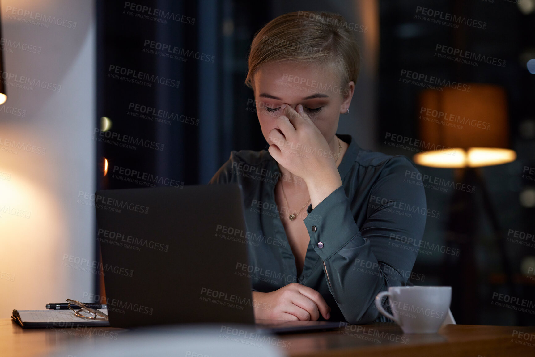 Buy stock photo Woman, night and office with laptop, headache and tired at finance planning job with burnout at desk. Corporate financial executive, computer and frustrated with pain, mental health and exhausted