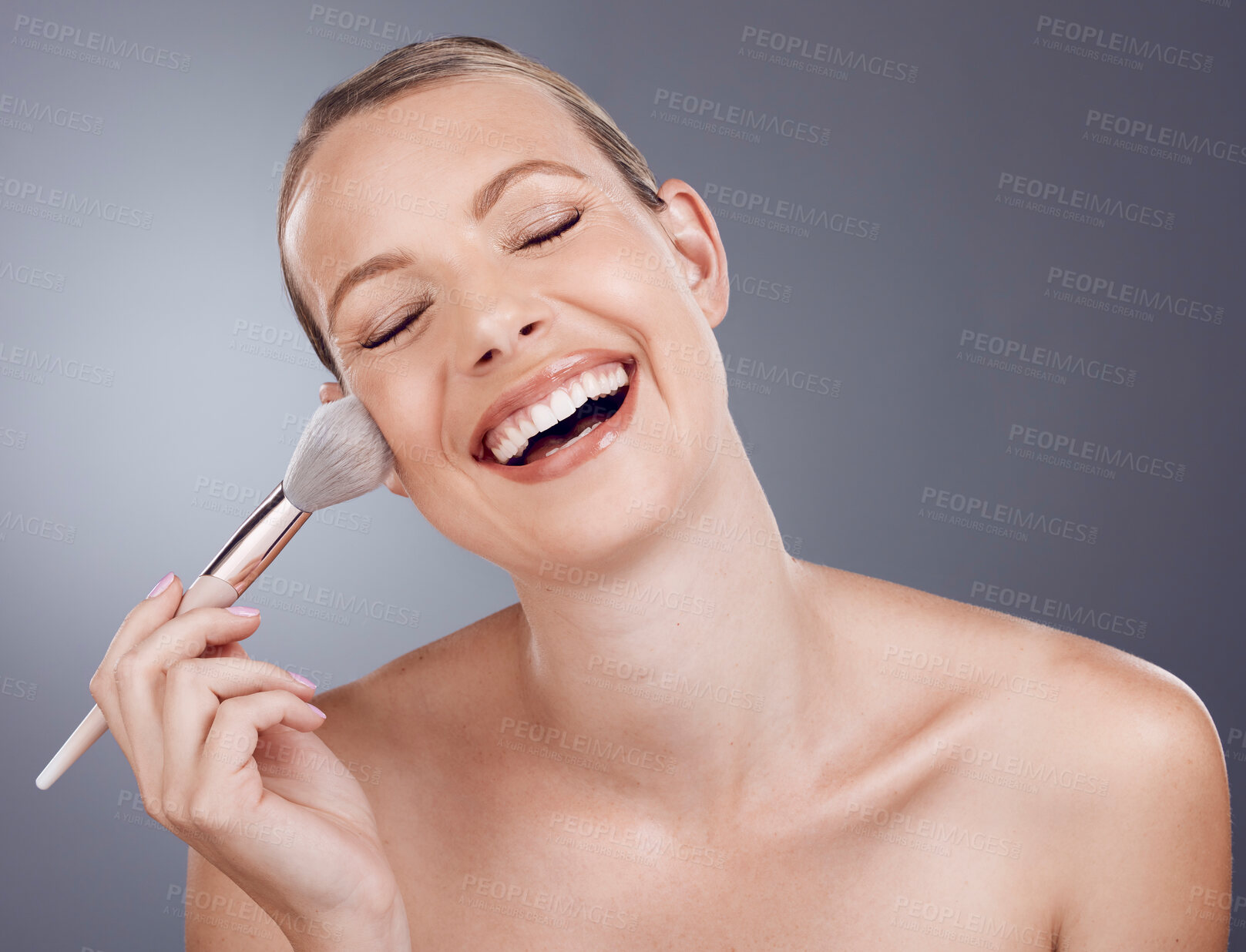 Buy stock photo Face, brush for makeup and woman with laughter, beauty and skin glow, funny and foundation on studio background. Powder, cosmetics tools and skincare, happy model with cosmetology and cosmetic care