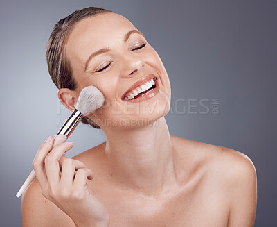 Buy stock photo Face, brush for makeup and woman with smile, beauty and skin glow, happy and foundation on studio background. Powder, cosmetics tools and skincare with shine, cosmetology and cosmetic care