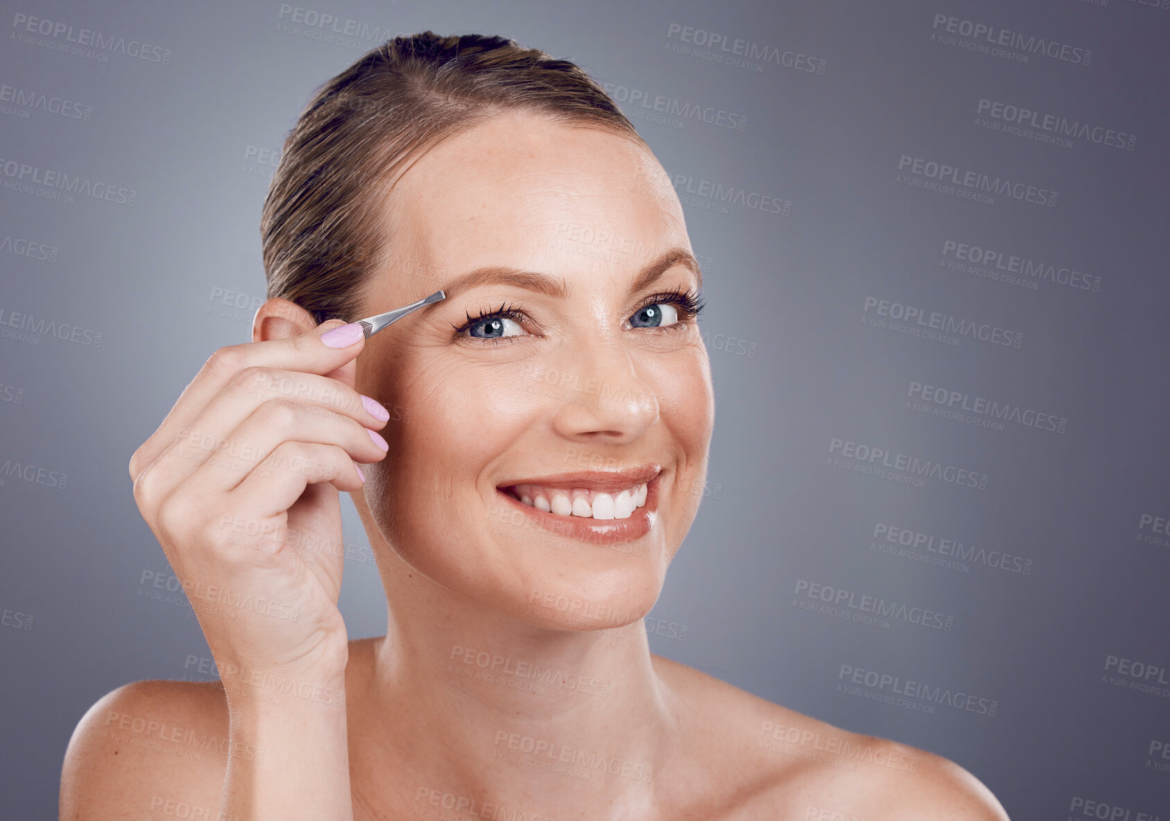 Buy stock photo Eyebrows, grooming and portrait of a woman with a tweezers isolated on a grey studio background. Beauty, treatment and happy model plucking hair from face for shaping and routine on a backdrop