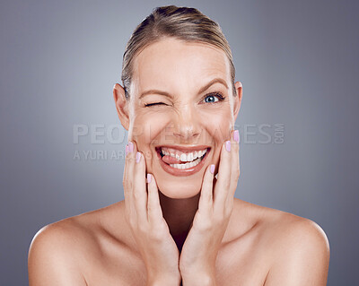 Buy stock photo Skincare, comic and portrait of a crazy woman isolated on a grey studio background. Funny, makeup and a model for cosmetics, beauty expression and showing humor on a backdrop with tongue out