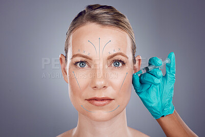 Woman, studio portrait and hands for plastic surgery, cosmetic transformation and beauty by gray background. Model, anti aging and headshot with injection, skincare and writing on face with surgeon