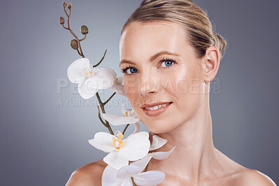Buy stock photo Beauty, flowers and skincare with portrait of woman for natural product, wellness and spa treatment. Cosmetics, relax and health with face of model and orchid plant for facial, self care and growth