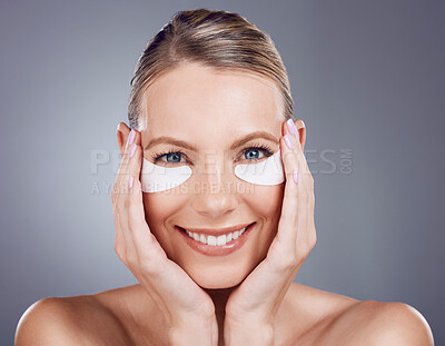 Buy stock photo Beauty mask, eyes and portrait of woman on gray background for wellness, cosmetics and facial treatment. Skincare, dermatology and happy girl smile with pads for anti aging, makeup and eye health