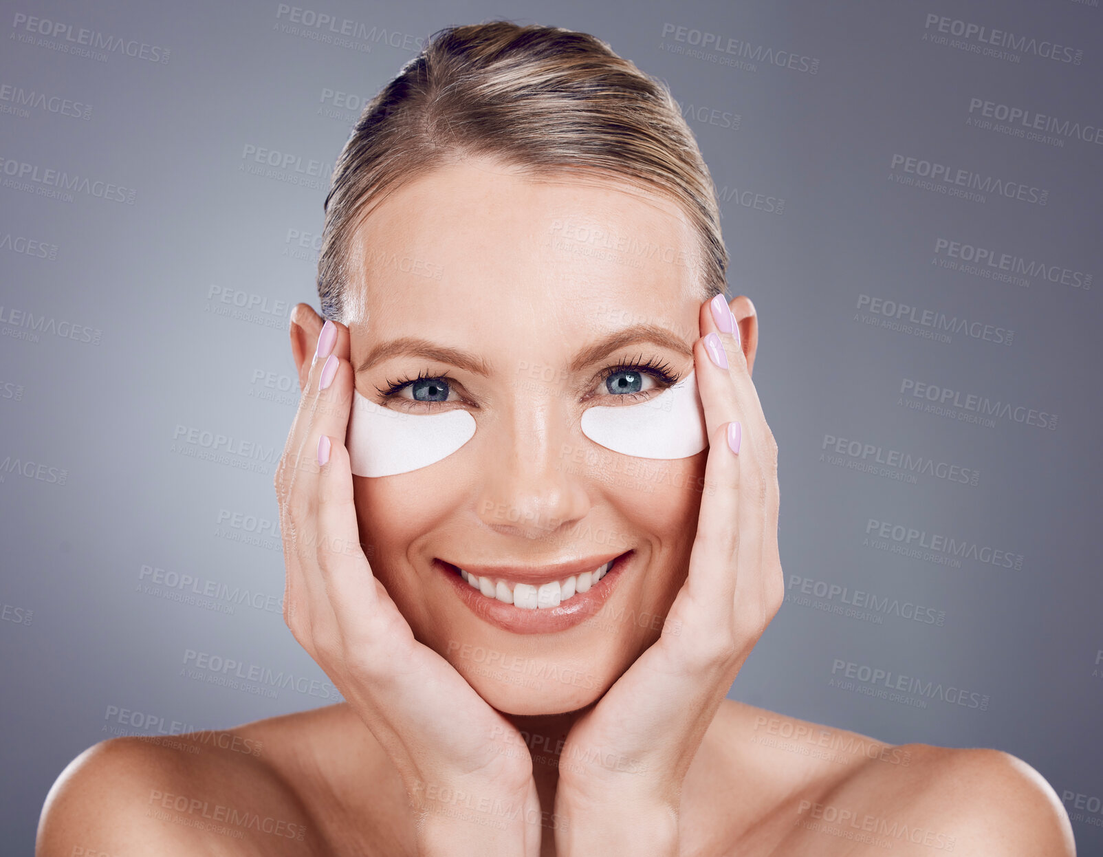 Buy stock photo Beauty mask, eyes and portrait of woman on gray background for wellness, cosmetics and facial treatment. Skincare, dermatology and happy girl smile with pads for anti aging, makeup and eye health