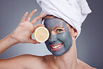Lemon, face mask and portrait of woman, healthy skincare and beauty of anti aging wellness makeup in studio. Happy female face, model and citrus fruits for vitamin c, aesthetic facial and shower glow