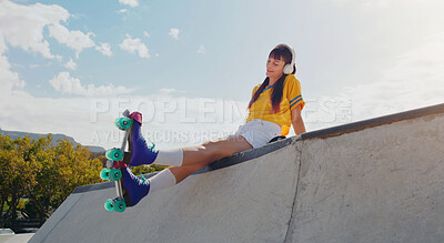 Buy stock photo Peace, music and rollerblades with woman in skate park for summer break, streaming and sports. Fitness, relax and skating with girl listening to headphones in outdoors for hobby, freedom and health