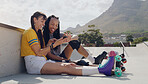 Friends, phone and women relax after roller skate training in a skate park browsing social media trend on the internet. Online, connected and extreme sports people resting and laughing at at meme 