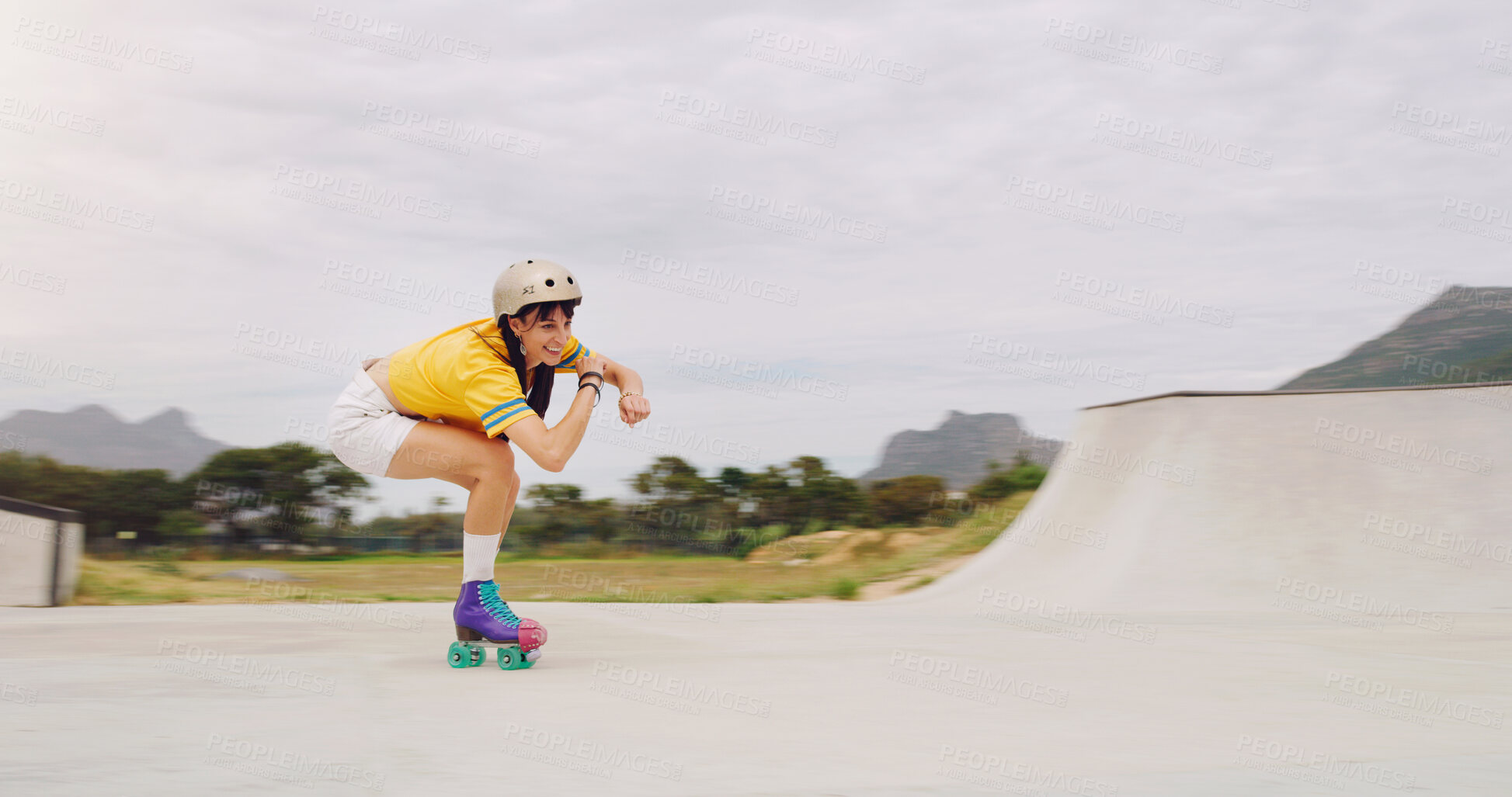 Buy stock photo Roller skate, extreme sports and woman riding fast with speed in a skate park with mockup space outdoors. Rollerskate, skater and female skating practicing or training  with safety helmet