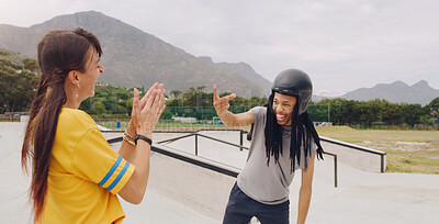 Buy stock photo Laughing, funny and interracial couple bonding while roller skating and learning to click fingers. Playful, applause and woman clapping for a black man clicking while on skates at a park for fun