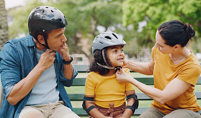 Buy stock photo Parents, park bench and helmet with child, helping hand and safety for skating, rollerskate or bike. Interracial parents, mom and dad with help, teaching and kid for bonding, learning and exercise