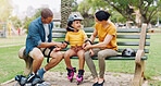 Family, support and interracial parents help kid with safety pads teaching her to rollerskate at the park and bonding outdoors. Mother, father and daughter learning to skate from mom and dad