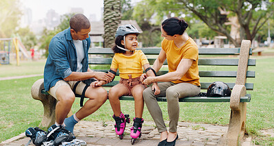 Buy stock photo Family, rollerskate and interracial parents help kid with safety pads teaching her skating at the park and bonding outdoors. Mother, father and daughter learning to skate from mom and dad