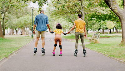 Buy stock photo Family, park and holding hands to rollerskate with girl child with care, learning and support. Interracial parents, black man and woman with kid, back and helping hand on road for outdoor holiday
