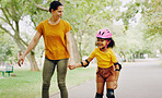 Mom, park and holding hands to rollerskate with child with care, learning and support. Interracial parent, teaching and woman with girl kid, smile and helping hand on road for skating on vacation