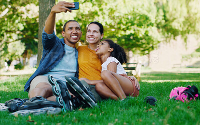 Buy stock photo Interracial family selfie, girl and park with rollerblades, bonding or smile for profile picture, happy or holiday. Black man, mom and child for happiness, hug or diversity for social media on grass