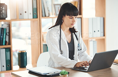 Buy stock photo Doctor, laptop and woman typing in hospital for research, online consultation or telehealth. Technology clinic, computer and female physician writing medical report, healthcare email or wellness app.