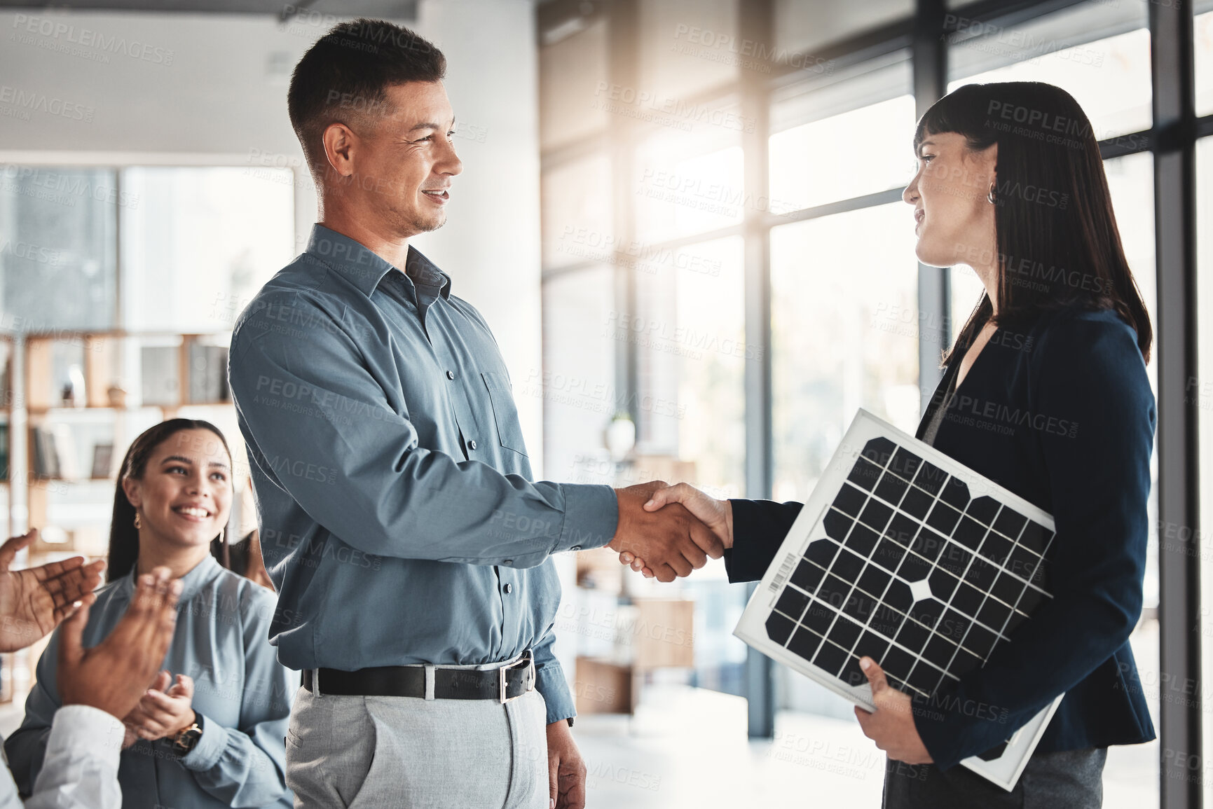 Buy stock photo Technician, deal and solar panels with people and handshake for renewable energy, teamwork and engineering. Future, technology and applause with group cheering for photovoltaic, product and success