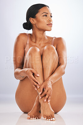 Buy stock photo Skincare, black woman and legs on studio floor for dermatology, laser wellness and background. Beauty, female and underwear model with body hair removal, natural glow and shine of aesthetic cosmetics