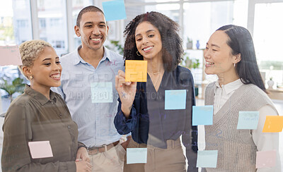 Buy stock photo Business people, writing and schedule planning in strategy or brainstorming on glass wall at office. Happy group of designers in teamwork with smile for project plan, tasks or post it and sticky note